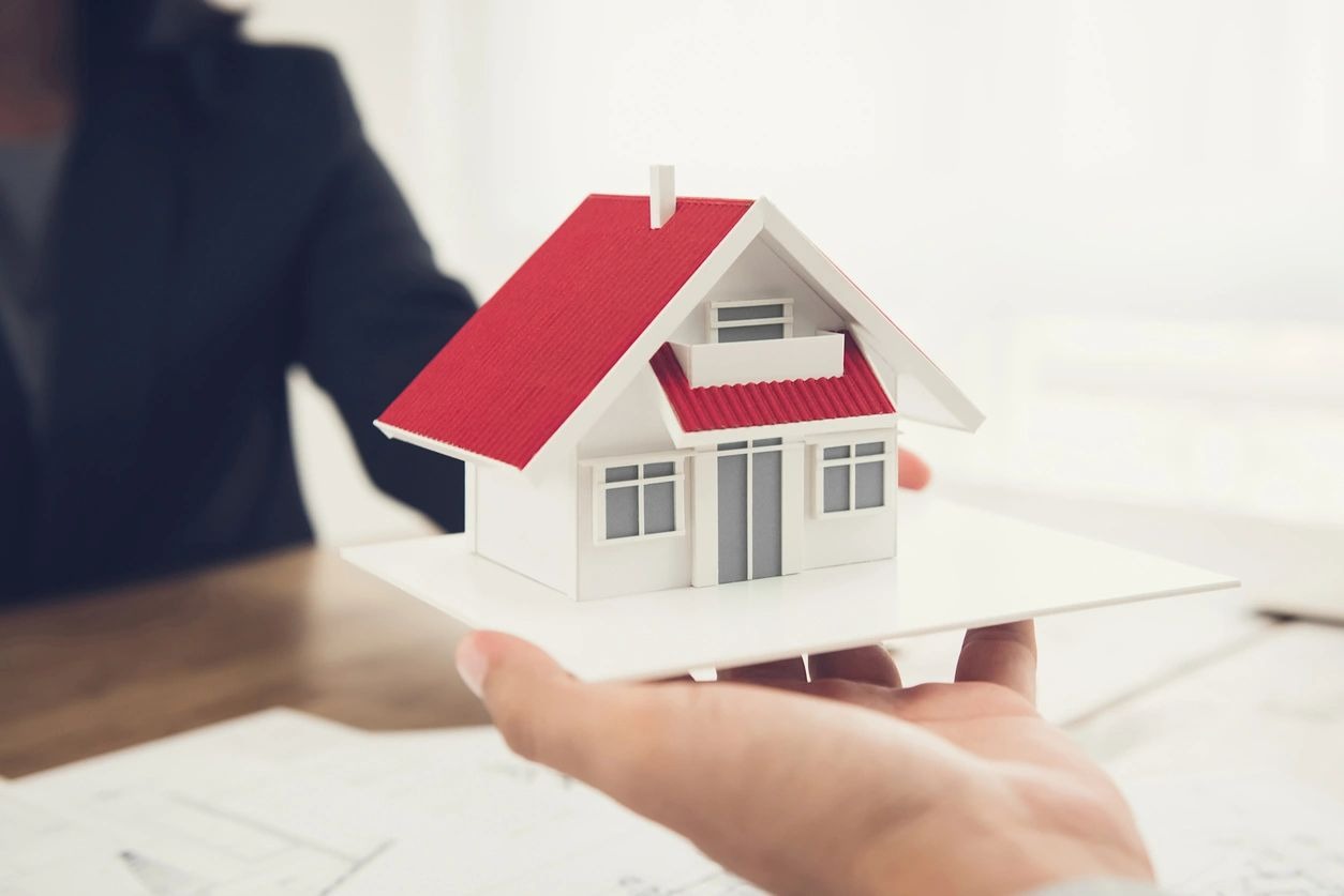 Man holding a small house