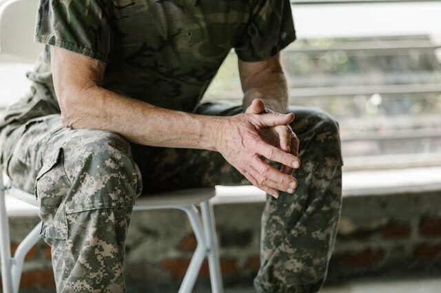 A US army veteran sitting on a chair