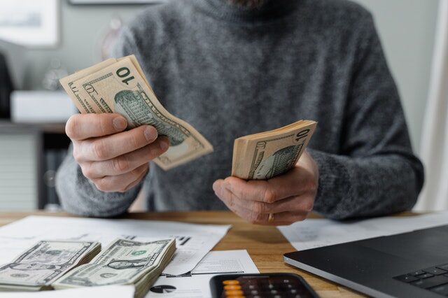  A mortgage broker counting ten-dollar notes