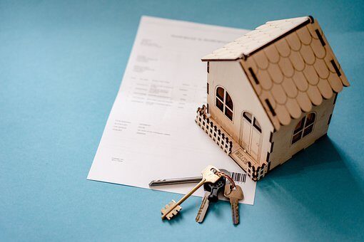 A house prop with keys over a loan application