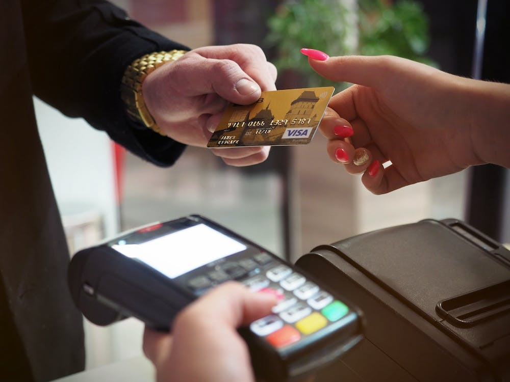 A person using their credit card on an EFTPOS machine